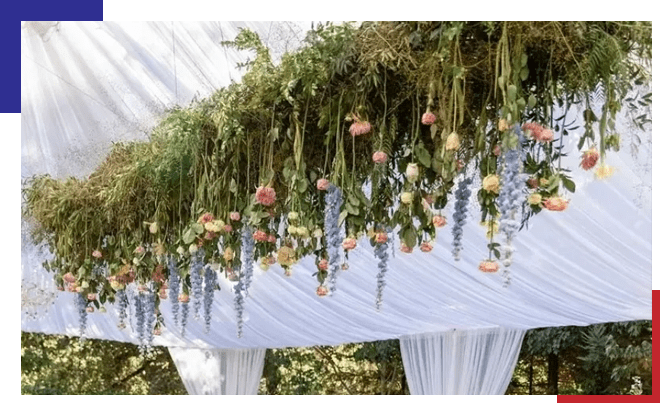 A canopy with flowers hanging from it's ceiling.