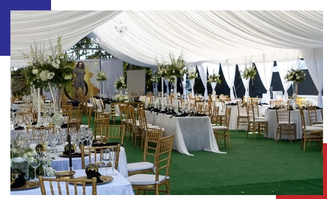 A large tent with many tables and chairs.