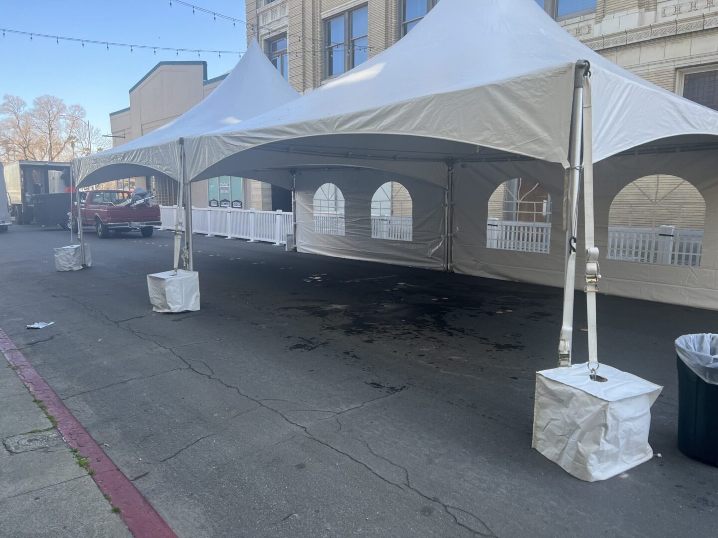 A white tent is set up on the street.