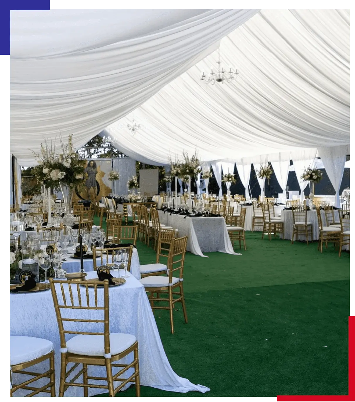 A large white tent with many tables and chairs.